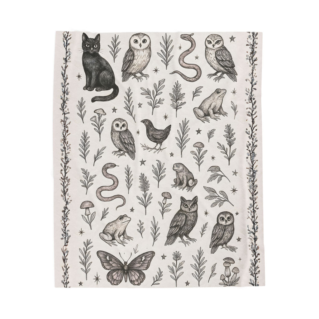 Patterned fabric with black and white illustrations of animals and plants on a light background