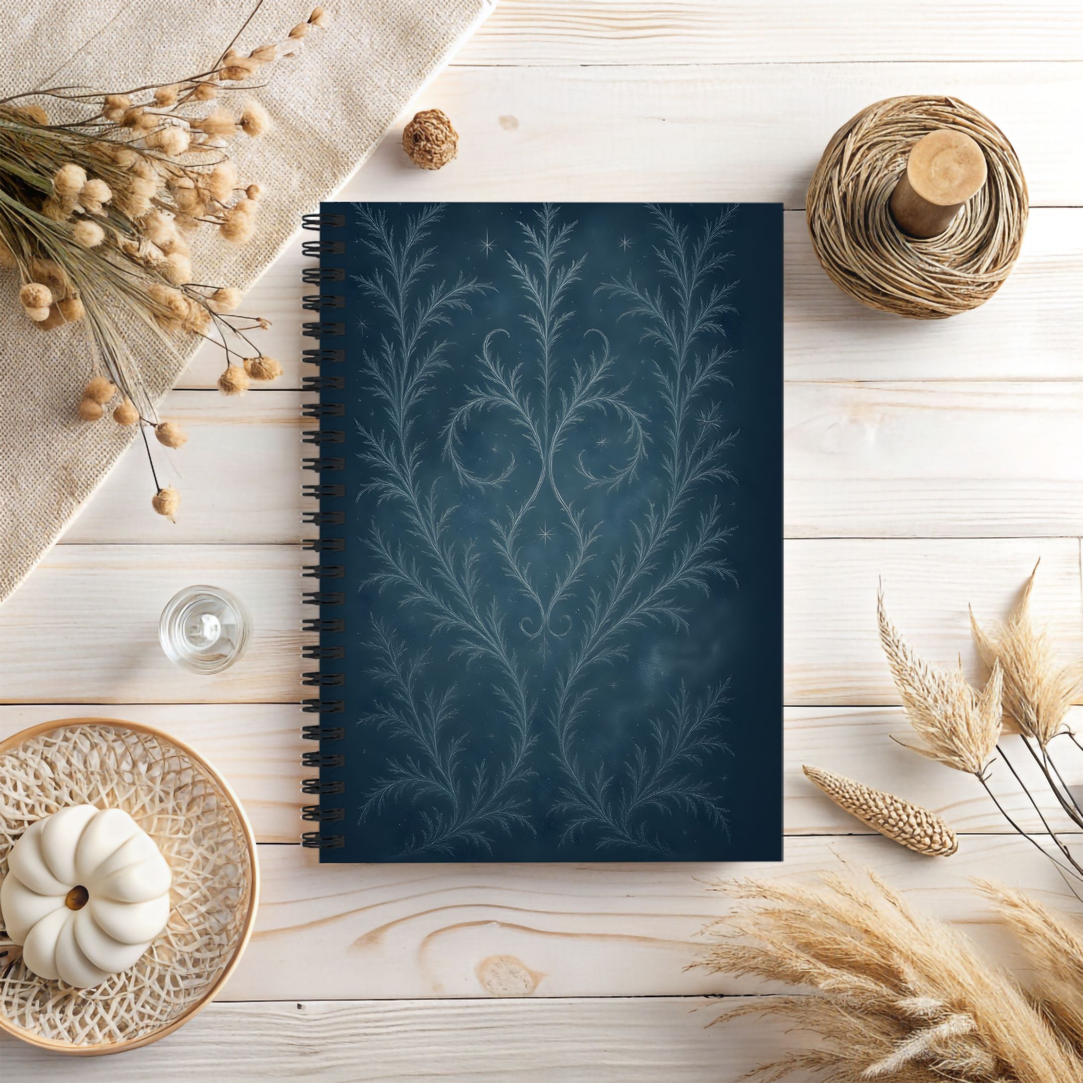 Notebook with decorative cover on a wooden surface with autumn elements