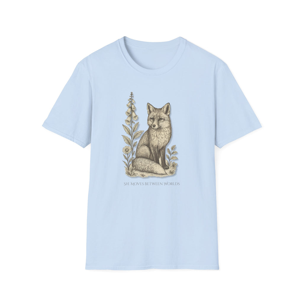 Light blue t-shirt with a fox and floral design on a white background. "She Moves Between Worlds" Fox T-Shirt