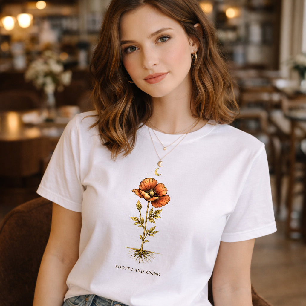 Woman wearing a white t-shirt with a floral design in a cozy indoor setting